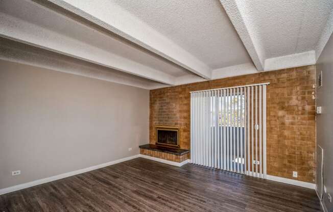 Living room with a fireplace and balcony access
