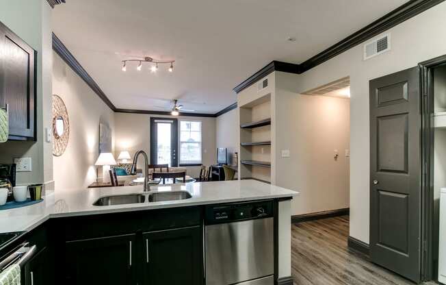 the view of a kitchen and living room from the counter top of a counter top