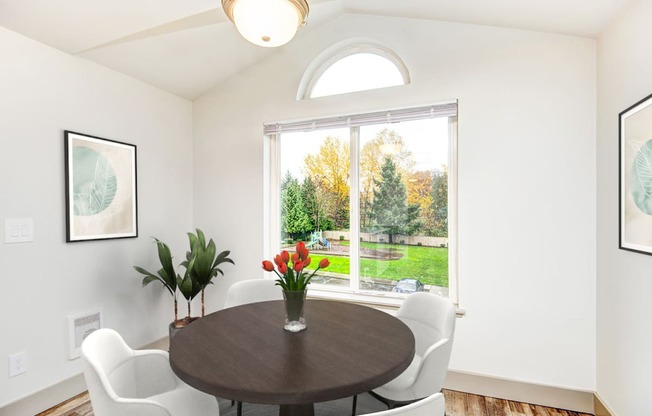 a dining room with a large window and a table