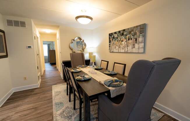 a dining room with a wooden table and chairs