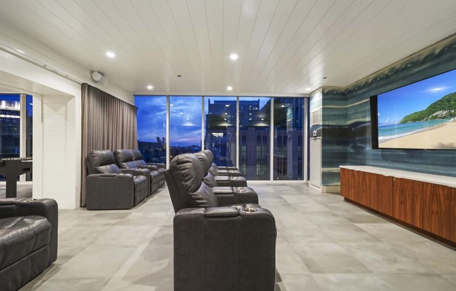 a large living room with couches and a large screen tv