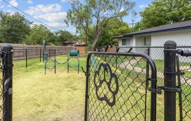 a backyard with a playground and a house in the background