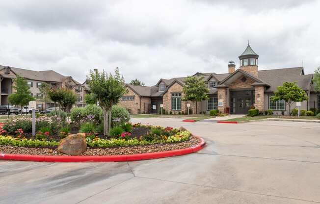 a large building with a flower garden in front of it