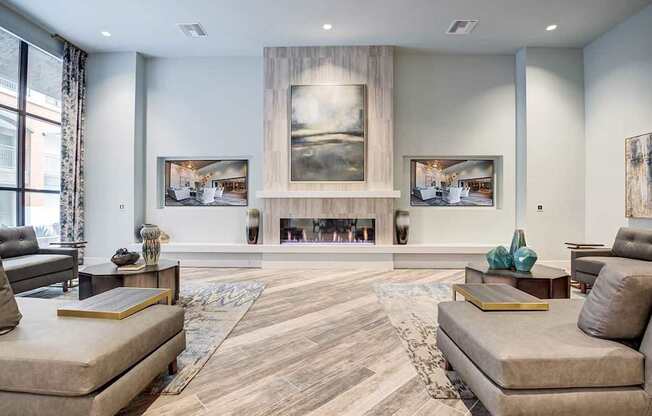 A living room with a fireplace and a painting on the wall.