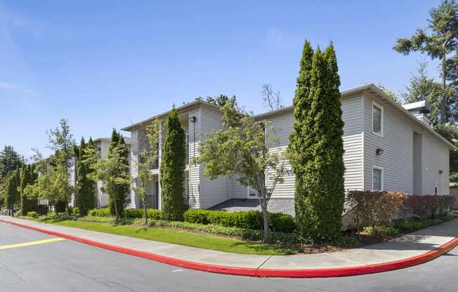 a street view of the property with landscaped trees at Park Edmonds Apartment Homes, Washington