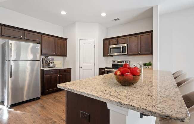 Harris Trail Luxury Townhomes for rent Richmond Hill, GA photo of a kitchen with stainless steel appliances and a granite counter top