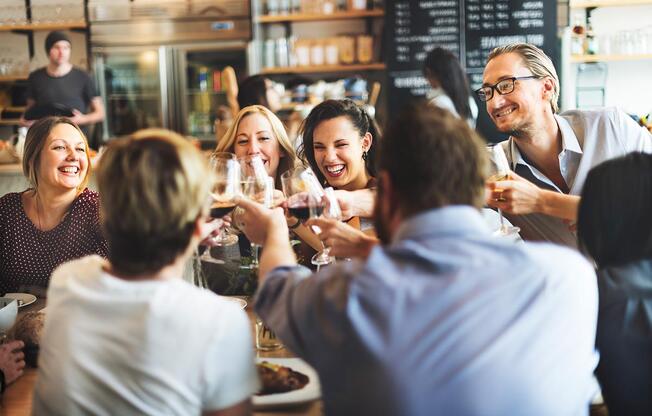 a group of people drinking wine at a restaurant