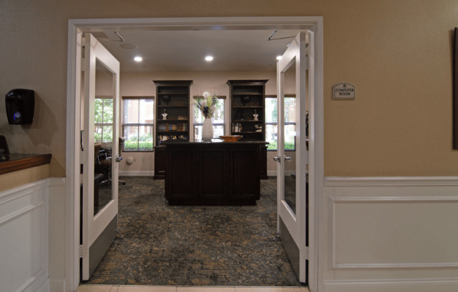 A room with a brown counter and a white door.,A room with a brown counter and a white door.