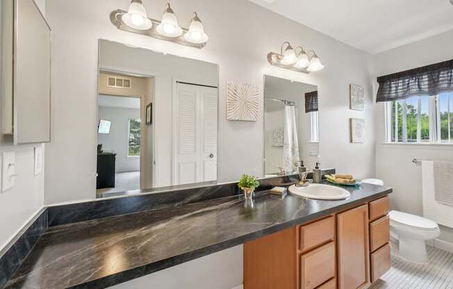 Spacious bathroom with ample storage at Drawbridge Apartments in Harrison Township, MI.