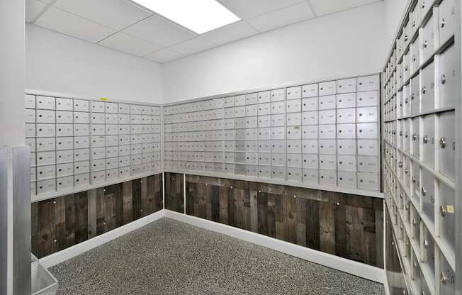 A room with a lot of mailboxes on the wall.