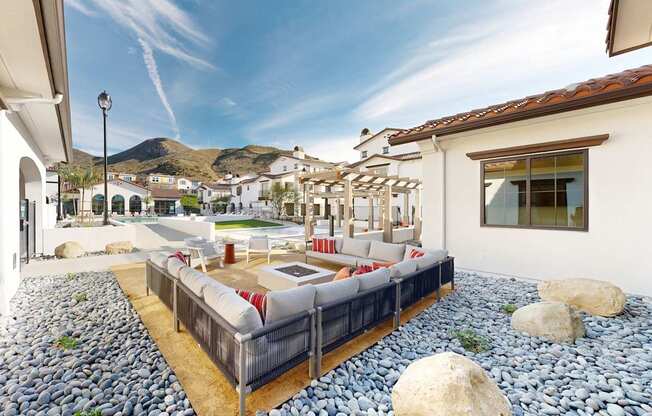 A patio with a couch and a table with a mountain in the background at The Villas at Anacapa Canyon, Camarillo, 93012