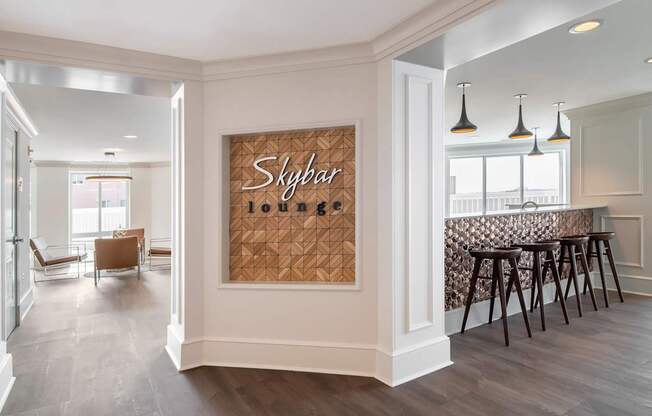 A room with a wooden floor and a wall hanging with the word Skybar on it.