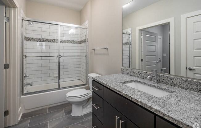 a bathroom with a sink and a toilet and a shower