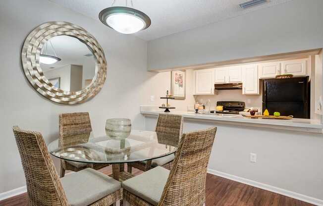 A dining room with a glass table and chairs.
