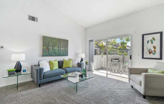 a living room with couches and a glass table