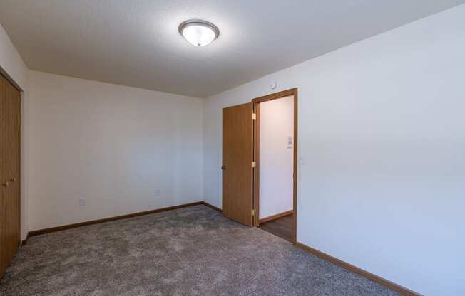 a bedroom with a closet. Fargo, ND Westwood Apartments