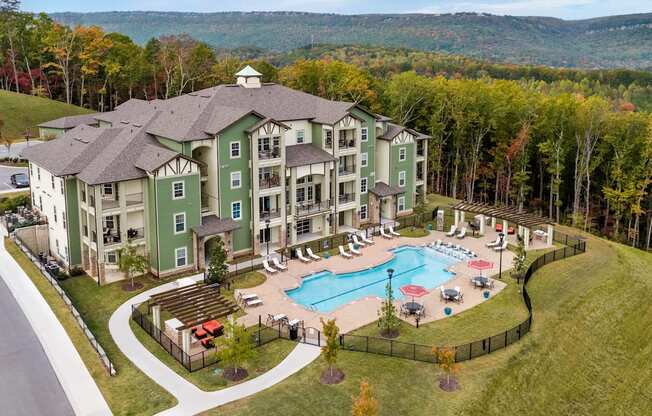 an aerial view of a resort building with a swimming pool