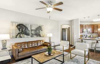 a living room with a ceiling fan and a couch