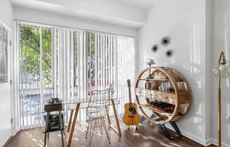 A room with a guitar and chair in it.