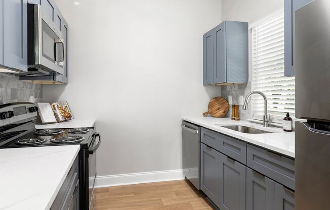 Kitchen with shaker style cabinets and stainless steel appliances