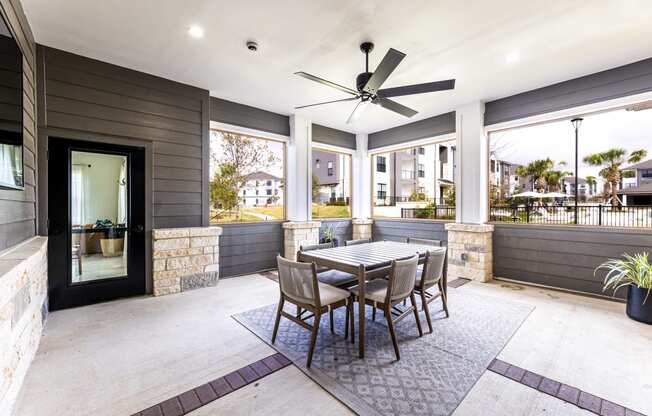 Dining area with a table and chairs and a ceiling fan at The Parker Austin, Pflugerville, Texas