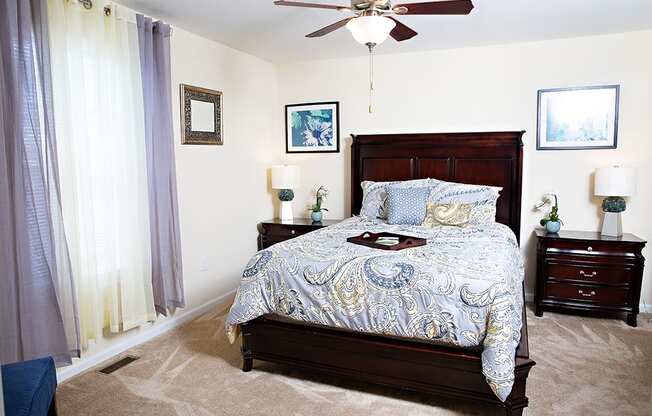 Bedroom with queen bed, dresser and night stands