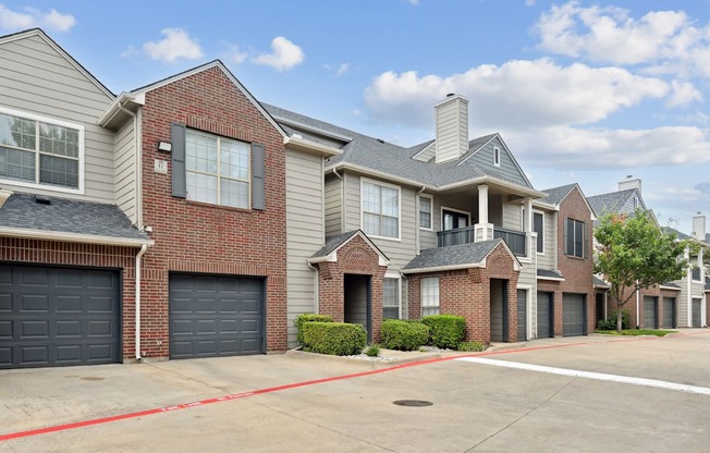 A row of houses with garages and driveways.