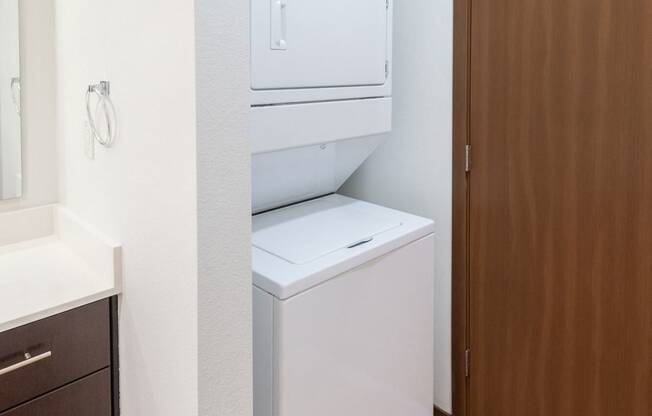 a bathroom with a washer and dryer in a closet