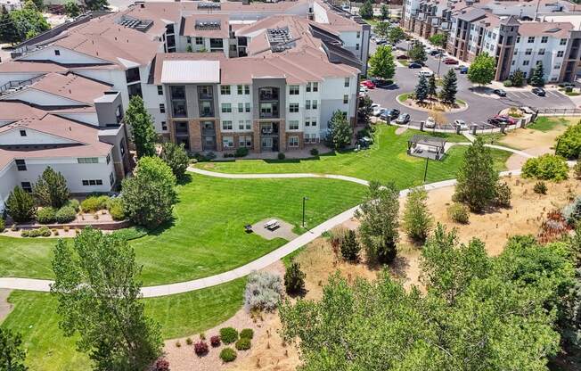 an aerial view of an apartment complex with a green park