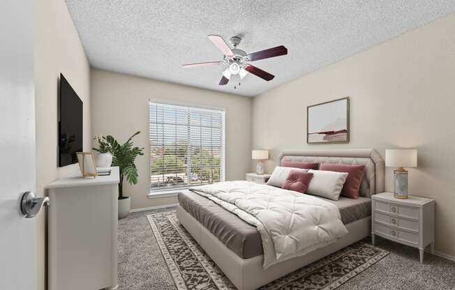 a bedroom with a large bed and a ceiling fan