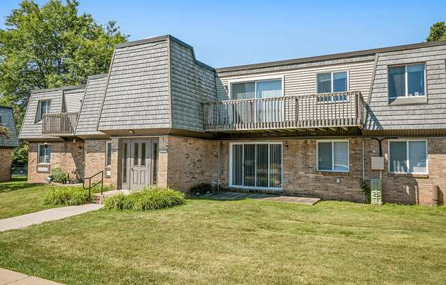 A brick building with a balcony and a sign that says