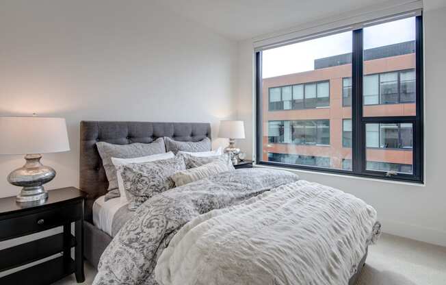 a bedroom with a large bed and a large window