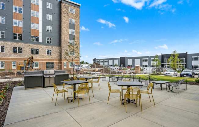 A sunny day at a modern outdoor seating area with tables and chairs.