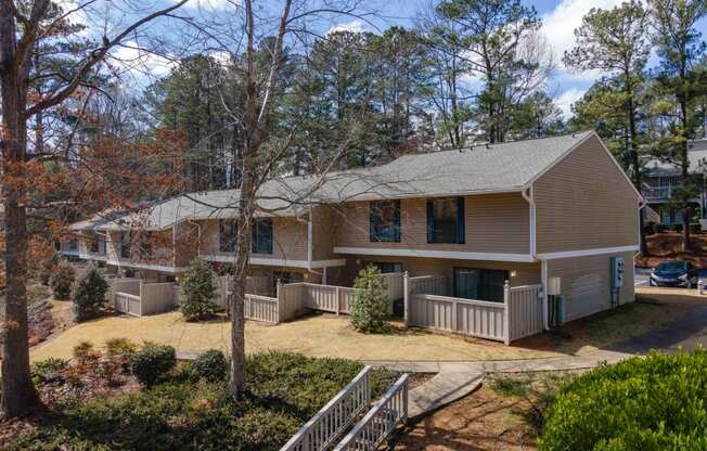 the front of a house with a yard and a deck