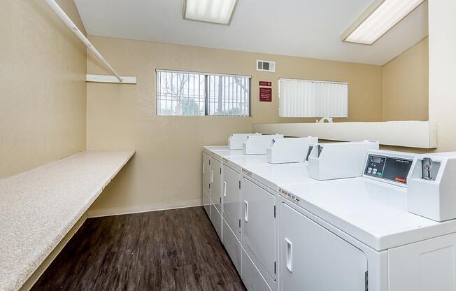 a kitchen with white appliances and wooden cabinets