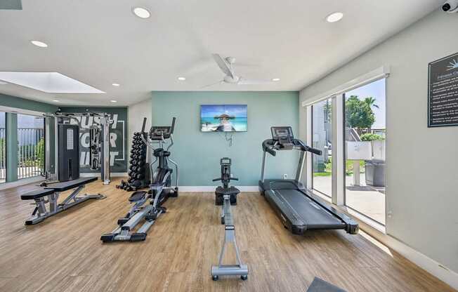 A spacious home gym with a variety of exercise equipment.
