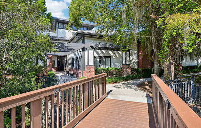 a balcony with a wooden deck and a building in the background