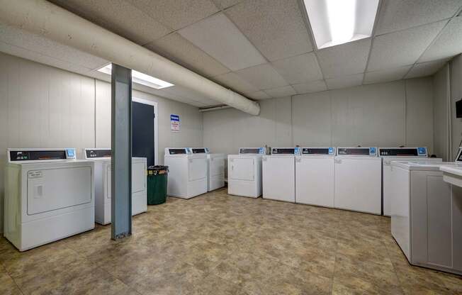 A laundry room with washers and dryers.