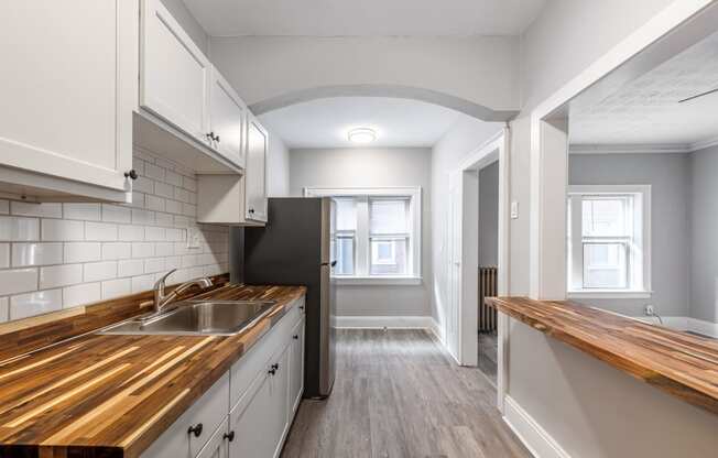 a kitchen with a wooden counter top and a sink