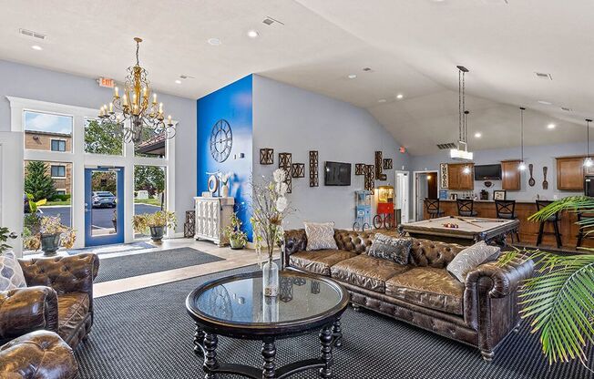 a living room with couches and a pool table