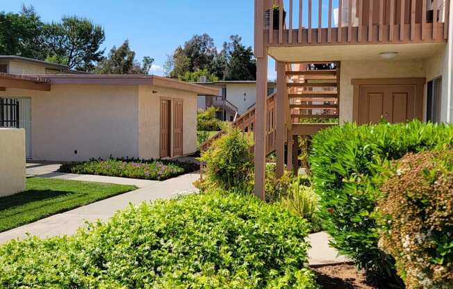 Beautiful landscaping outside apartment units at Plaza Verde Apartments in Escondido, California.