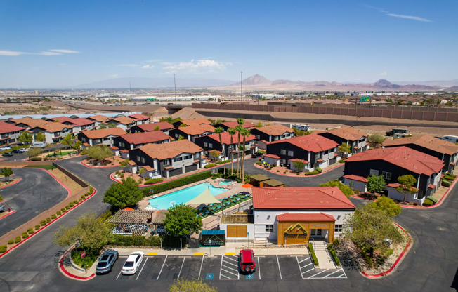 A large building complex with a pool in the middle.