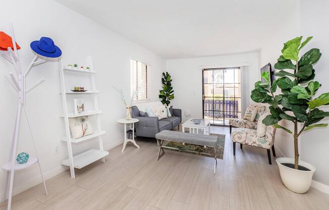 a living room filled with furniture and a large window