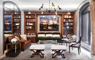 a living room filled with furniture and a fire place sitting in a chair