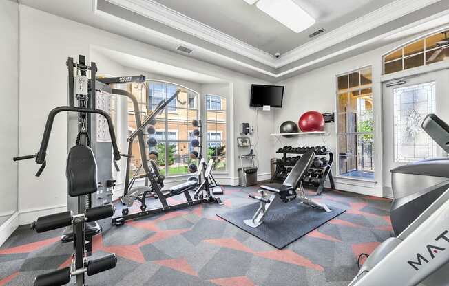 a home gym with exercise equipment and a window