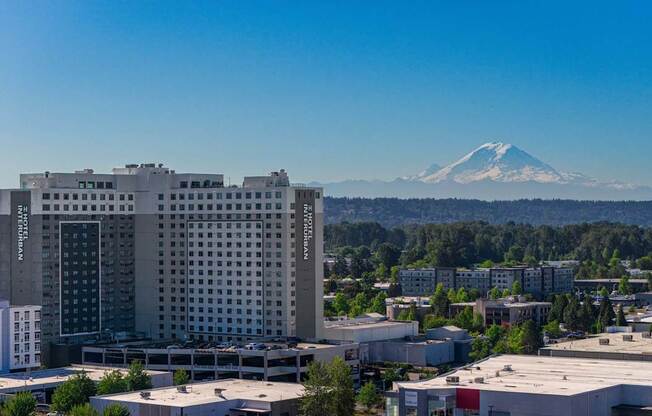 A large building with a mountain in the background.