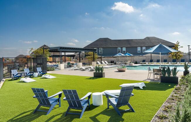 An open-air pool setting with shaded seating and lounge areas offers space to unwind, gather, and enjoy time outdoors within the community.