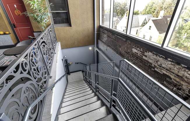 a view of the balcony with stairs and a brick wall at The Knights @ 506 Delaware Apartments, New York, 14202