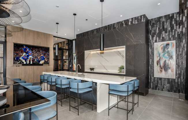 a kitchen with a large center island with a marble countertop