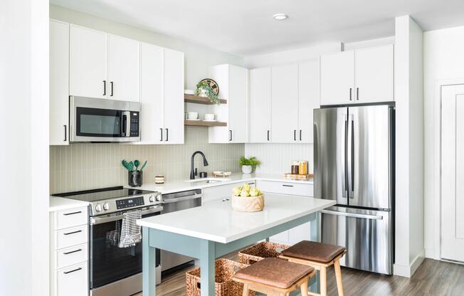 Crisp white cabinetry, stainless steel appliances, and coastal-inspired details bring warmth and ease to Modera South Shore kitchens.